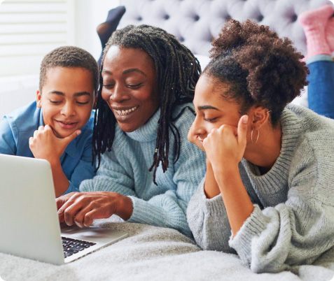 A mother and her two children review finances on the laptop together