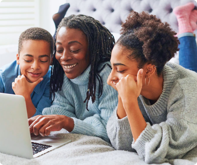 A mother and her two children review finances on the laptop together